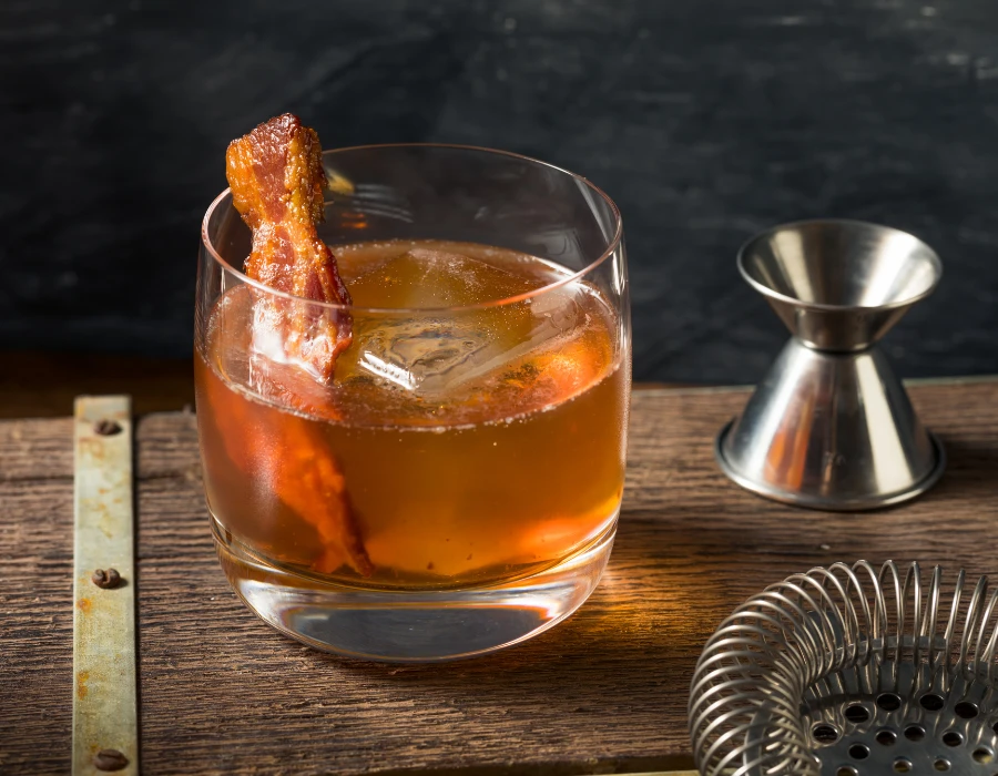 smokey vodka cocktail with bacon as garnish